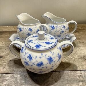 Arzberg 'Blue Flowers' porcelain sugar bowl and two creamer pitchers.